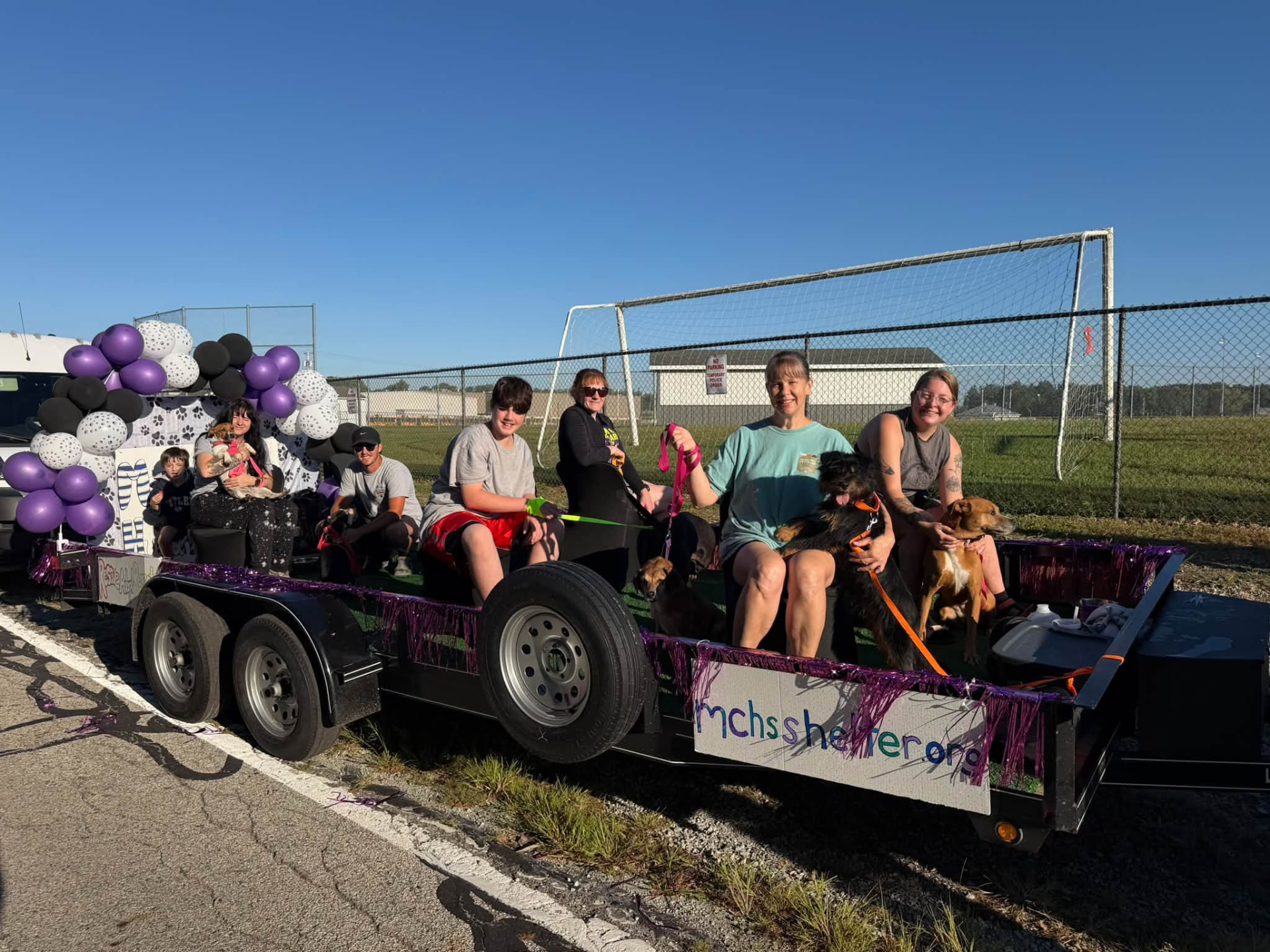 The full Marshall County Humane Society parade float with volunteers, dogs and the mchsshelter.org banner